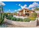 Expansive backyard with lush greenery, an outdoor fireplace, and a private patio for relaxing and entertaining at 22633 N Clubhouse Way, Scottsdale, AZ 85255