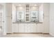 Modern bathroom with dual sinks, granite countertops, custom cabinetry, and stylish backsplash at 22633 N Clubhouse Way, Scottsdale, AZ 85255