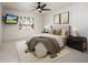 Cozy bedroom with large windows, plush carpet, ceiling fan, and two bedside tables at 22633 N Clubhouse Way, Scottsdale, AZ 85255