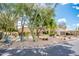 Desert landscaping and mature trees surround this charming single-story home with a two-car garage at 22633 N Clubhouse Way, Scottsdale, AZ 85255