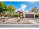 Well-maintained front yard with desert landscaping, mature trees, and a charming home exterior at 22633 N Clubhouse Way, Scottsdale, AZ 85255