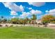 Picturesque view of the golf course with a manicured green and a beautiful home in the background at 22633 N Clubhouse Way, Scottsdale, AZ 85255