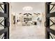 Elegant foyer and living room boasting high ceilings, decorative chandeliers, and stylish furnishings at 22633 N Clubhouse Way, Scottsdale, AZ 85255