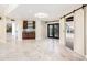 Bright living room features marble floors, custom cabinets and countertops, plus black framed french doors at 22633 N Clubhouse Way, Scottsdale, AZ 85255