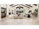 Spacious living room featuring high ceilings, a marble fireplace, and a plush sofa with backyard view at 22633 N Clubhouse Way, Scottsdale, AZ 85255