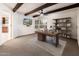 Home office with a custom desk, hardwood floors, wooden ceiling beams, and lots of natural light at 22633 N Clubhouse Way, Scottsdale, AZ 85255
