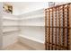 Well-organized pantry with shelving and storage for wine and food items at 22633 N Clubhouse Way, Scottsdale, AZ 85255
