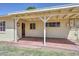 Inviting back porch with brick flooring and access to the home's interior at 2419 W Shady Glen Ave, Phoenix, AZ 85023