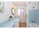 Charming bathroom featuring a tile countertop, bathtub, and vanity mirror at 2419 W Shady Glen Ave, Phoenix, AZ 85023