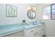 Charming bathroom features a tile countertop, vanity mirror, and bright window at 2419 W Shady Glen Ave, Phoenix, AZ 85023