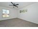 Large bedroom with neutral carpet and a bright window with neighborhood views at 2419 W Shady Glen Ave, Phoenix, AZ 85023