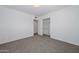 A bright bedroom with closet and neutral carpeting at 2419 W Shady Glen Ave, Phoenix, AZ 85023