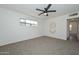 The bedroom features carpet, a modern ceiling fan, and bright windows at 2419 W Shady Glen Ave, Phoenix, AZ 85023