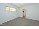 A bright bedroom with large window and neutral carpeting at 2419 W Shady Glen Ave, Phoenix, AZ 85023