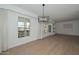 Sunlit dining area features neutral walls, wood floors, contemporary light fixture, and large windows at 2419 W Shady Glen Ave, Phoenix, AZ 85023