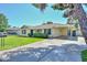 Single-story home with blue shutters, a well-maintained lawn, and a covered parking area at 2419 W Shady Glen Ave, Phoenix, AZ 85023