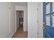 Hallway leading to laundry room and front door at 2419 W Shady Glen Ave, Phoenix, AZ 85023
