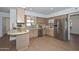 Traditional kitchen with tiled countertops, stainless steel appliances, and wood cabinets offers plenty of storage at 2419 W Shady Glen Ave, Phoenix, AZ 85023