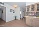 Kitchen nook with views to the hall and bathroom boasts wood-look flooring and white wainscoting at 2419 W Shady Glen Ave, Phoenix, AZ 85023