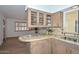 This kitchen features tan countertops, glass cabinets, and stainless steel sink at 2419 W Shady Glen Ave, Phoenix, AZ 85023
