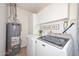 Laundry room with front loading washer and dryer, and storage at 2419 W Shady Glen Ave, Phoenix, AZ 85023