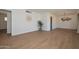 Spacious living room with hardwood floors, modern light fixture, and neutral walls at 2419 W Shady Glen Ave, Phoenix, AZ 85023