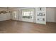 Bright living room with hardwood floors, large windows with curtains, and a built-in bookshelf at 2419 W Shady Glen Ave, Phoenix, AZ 85023