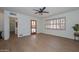 Light and bright living room with wood-look flooring and shuttered windows at 2419 W Shady Glen Ave, Phoenix, AZ 85023