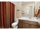 Bathroom features a vanity with ample storage, a toilet, and a shower with colorful curtain for privacy at 24280 N 164Th Dr, Surprise, AZ 85387