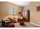 Sitting area with Southwestern decor, including a plush armchairs and wooden cabinet at 24280 N 164Th Dr, Surprise, AZ 85387