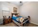 Charming bedroom featuring a wooden bed frame, carpet flooring, and a window to let in natural light at 24280 N 164Th Dr, Surprise, AZ 85387