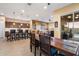 Open-concept dining area seamlessly connects to the kitchen and living room, with sliding door access to the patio at 24280 N 164Th Dr, Surprise, AZ 85387