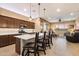Modern kitchen with a large center island, breakfast bar, stainless steel appliances, and open access to the living area at 24280 N 164Th Dr, Surprise, AZ 85387