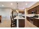 The kitchen features a central island with seating, stainless steel appliances, and plenty of cabinet space at 24280 N 164Th Dr, Surprise, AZ 85387