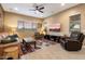 Cozy living room with comfortable seating, stylish decor, and a ceiling fan, bathed in soft, natural light at 24280 N 164Th Dr, Surprise, AZ 85387