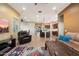 Bright living room showcases wood-look tile flooring, recessed lighting, comfortable seating, and a seamless connection to the kitchen at 24280 N 164Th Dr, Surprise, AZ 85387