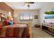 Charming main bedroom showcases a rustic log bed, ample sunlight, and a wall-mounted TV for entertainment at 24280 N 164Th Dr, Surprise, AZ 85387