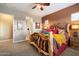 Stylish main bedroom features carpet flooring, rustic log bed frame, neutral wall color, and ensuite access at 24280 N 164Th Dr, Surprise, AZ 85387