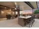 Covered outdoor kitchen and patio seating under a ceiling fan, perfect for entertaining at 24280 N 164Th Dr, Surprise, AZ 85387