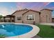 Sparkling pool with desert landscaping and a covered patio off the back of the house at 24280 N 164Th Dr, Surprise, AZ 85387