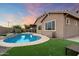 Inviting backyard pool with lush turf and desert landscaping offers a relaxing outdoor oasis at 24280 N 164Th Dr, Surprise, AZ 85387