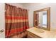 Bathroom features neutral walls, and a brown and red shower curtain at 2445 W Yuma St, Phoenix, AZ 85009