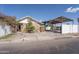 Charming single-story home with stone facade and covered parking, located on a tree-lined street at 2445 W Yuma St, Phoenix, AZ 85009