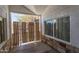 Enclosed front porch featuring a window, security gate, and stone accents at 2445 W Yuma St, Phoenix, AZ 85009