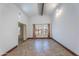 Bright living room features neutral paint, tile flooring, and vaulted ceilings with exposed beams at 2445 W Yuma St, Phoenix, AZ 85009