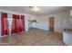 Open-concept living room with tile flooring and natural light, next to the kitchen at 2445 W Yuma St, Phoenix, AZ 85009