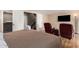 Cozy bedroom features two plush chairs, a flatscreen TV, and a neutral color scheme at 2524 S El Paradiso -- # 122, Mesa, AZ 85202