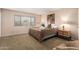 Comfortable bedroom featuring a large window, a cozy bed, and soft carpeting at 2524 S El Paradiso -- # 122, Mesa, AZ 85202