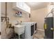 Functional laundry room with modern washer, dryer, utility sink and storage at 2524 S El Paradiso -- # 122, Mesa, AZ 85202