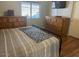 Cozy bedroom with wood floors and ample storage space in two wooden dressers at 2649 N 85Th Ave, Phoenix, AZ 85037